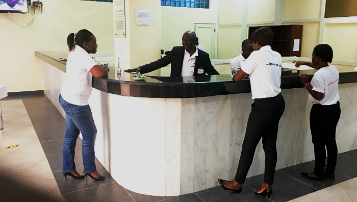  Mr. Isaac Shedowo interacting with some staff and customers of the bank at the Takoradi branch yesterday